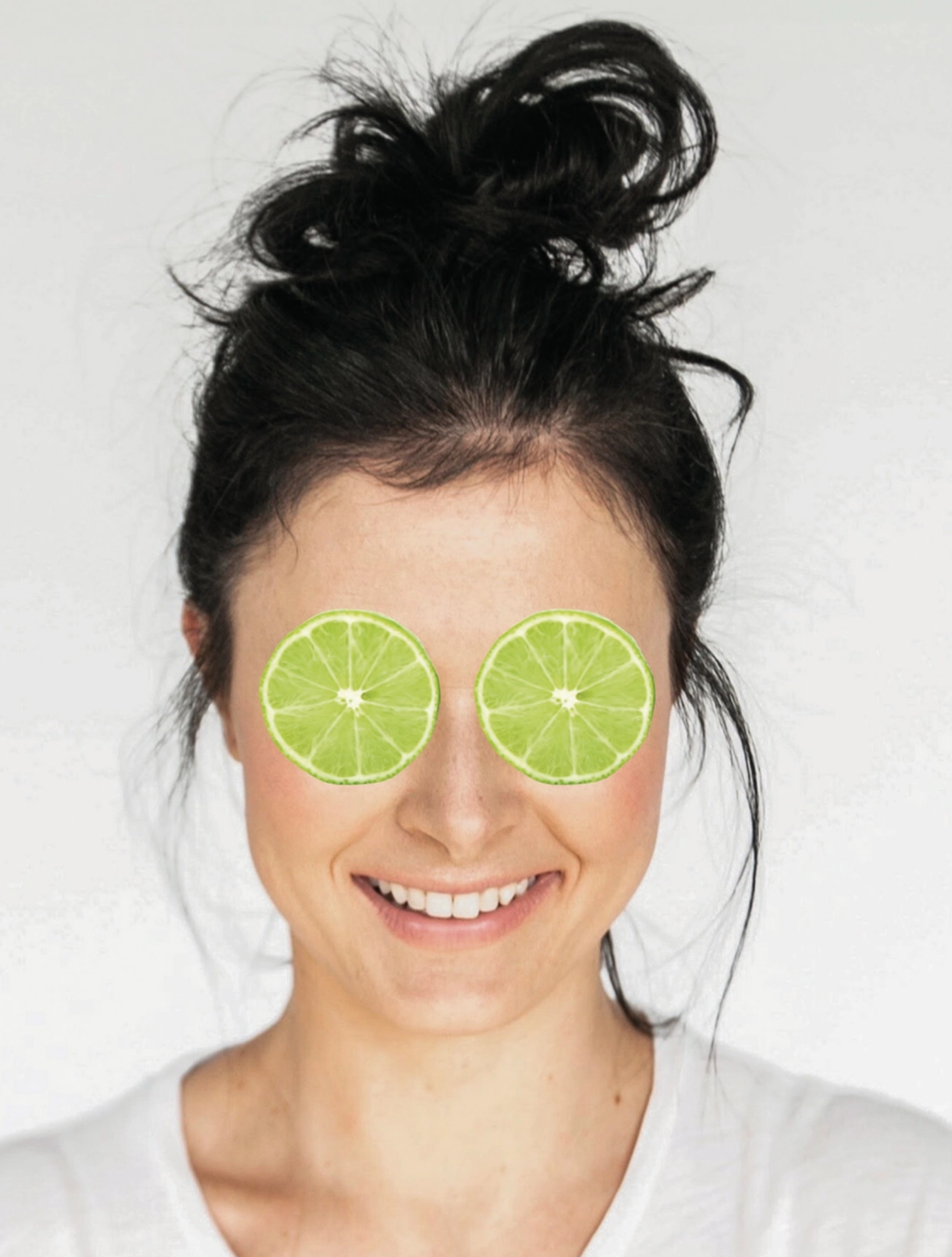 a person with slices of lime on her eyes
